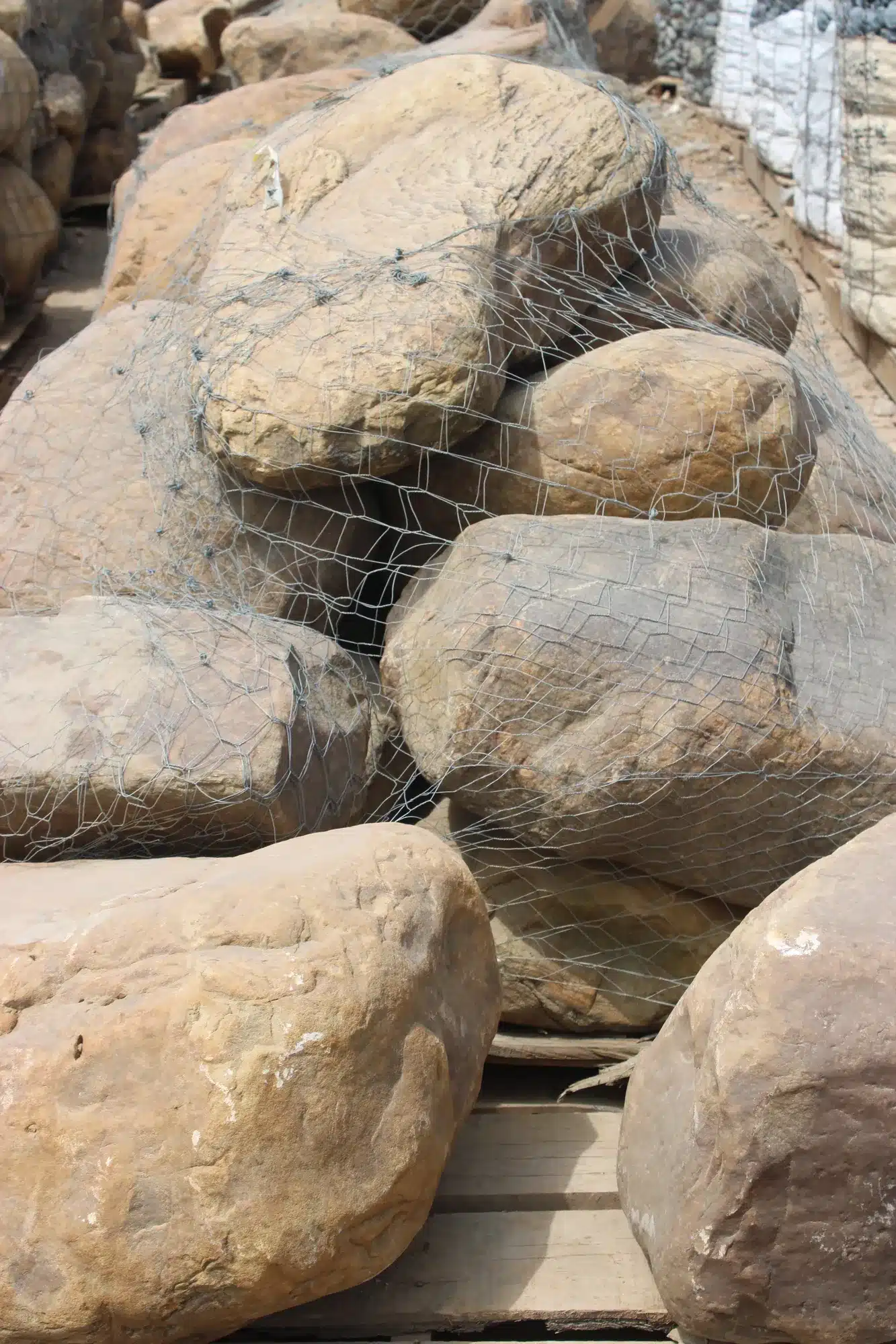 Dry creek bed landscaping channel with river rock in a McKinney yard