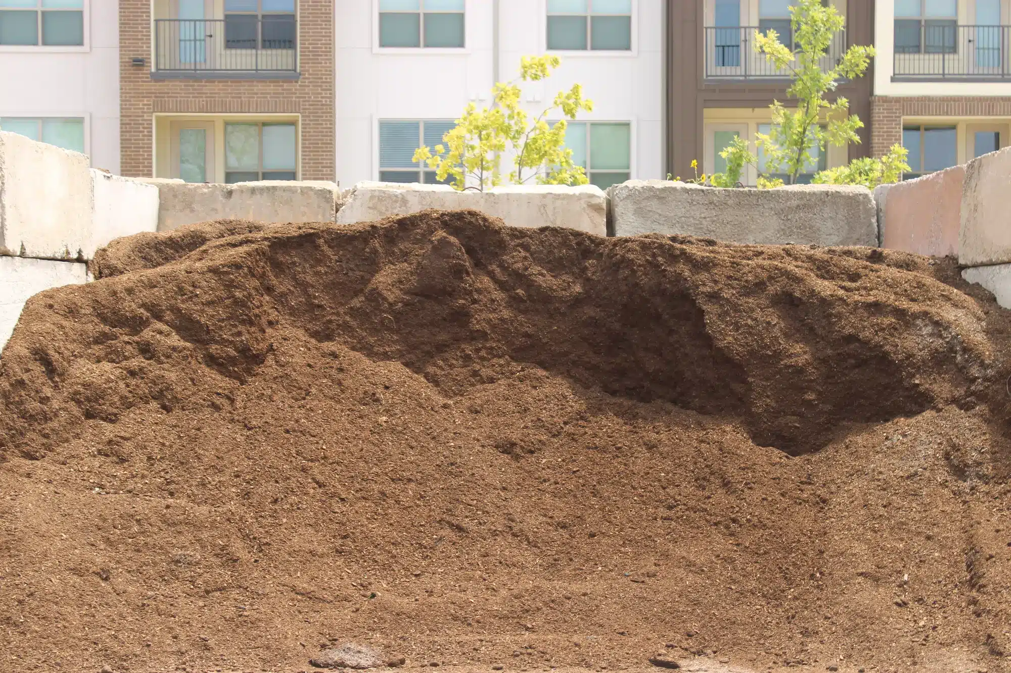 Mixing bulk compost into a McKinney garden bed